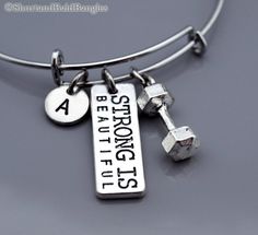 "❖ Dumbbell Charm: Antique Silver Pewter. Approx: 5/8 X 1/4\" ❖ Strong is beautiful in Antique silver pewter. Approx: 1&1/16 X 3/8 ❖ Hand Stamped Initial Charm - Antique silver pewter 3/8\" (9mm) ❖ Bangle: Silver plated metal (Expandable) Dimension: Approx. 2.5\" (6.4 cm) - Expands to 3\" (7.6 cm) ❖ Add a birthstone or freshwater pearl $3.50 each: https://www.etsy.com/listing/110444872 ❖ Additional Hand Stamped Initial charms $4.50 each: https://www.etsy.com/listing/107021419 ❖ Go back to Short Thor's Hammer Necklace, Strong Is Beautiful, Bracelet Initial, Bangle Silver, Silver Paint, Initial Bracelet, Personalized Bracelets, Charm Bangle, Initial Charm