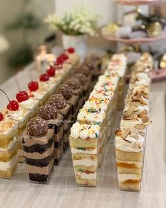 many desserts are lined up on a table