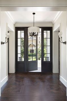 an entry way with black doors and white walls