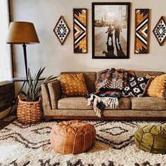 a living room filled with lots of furniture and pictures on the wall above it's couch