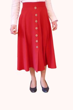 Long red semi-circle skirt. -Long red skirt, made of polyester crepe. -Custom-made skirt: indicate your waist measurement and desired length, for a skirt perfectly suited to your body shape! -This skirt is fluid and very full; It has a decorative button placket on the front, the buttons are wood colored. -The back of the skirt is closed with an invisible zipper and the hem is sewn with invisible stitches by hand. An elegant and pleasant skirt to wear! Product made to order in my workshop in Brit Red Pleated A-line Maxi Skirt, Red Lined Midi Skirt, Red Midi Lined Skirt, Red Midi Skirt With Lining, Red Midi Skirt For Workwear, Red Relaxed Full Skirt, Red Flared Pleated Skirt For Work, Red Full Skirt With Relaxed Fit, Red Fitted Full Pleated Skirt