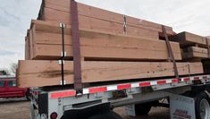 a large truck loaded with wooden planks on the back