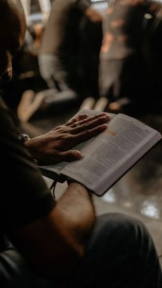 a person sitting down reading a book