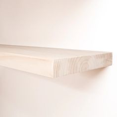 a wooden shelf mounted on the wall