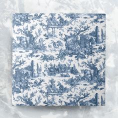 a blue and white toiler print paper on a marble surface with an image of people in the woods