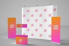 an exhibition stand with colorful signage on the wall and two stands for advertising purposes,