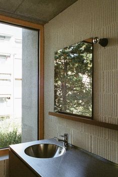 a bathroom sink sitting under a mirror next to a window