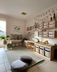 a child's playroom with lots of storage and toys