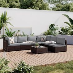 an outdoor living area with furniture and plants