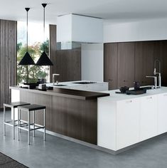 a modern kitchen with an island and bar stools