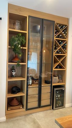 a wine rack in the corner of a room with shelves full of bottles and glasses