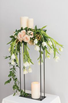 candles and flowers are arranged on the table