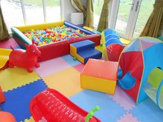 an indoor play area with soft foam balls and toys