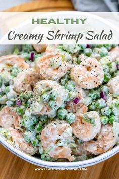 a bowl filled with shrimp salad on top of a wooden table and text overlay reads healthy creamy shrimp salad