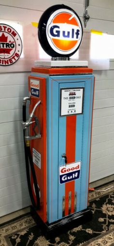 an old fashioned gas pump sitting on top of a rug in front of a wall