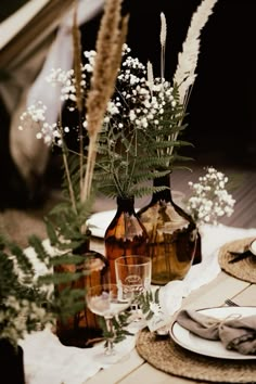 the table is set with flowers and plates