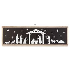 a black and white nativity scene with the birth of jesus in silhouette on a wooden frame