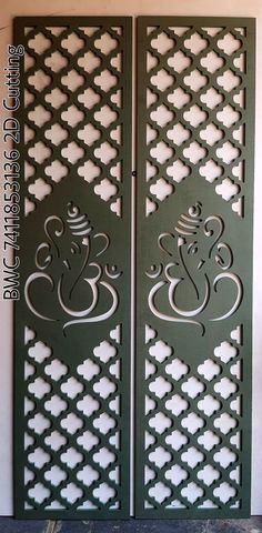 two green doors with intricate designs on them