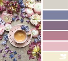 a cup of coffee sitting on top of a saucer next to purple and white flowers