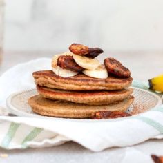 a stack of pancakes with banana slices on top