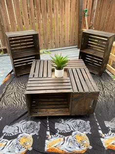 a table and chairs made out of pallet wood with a potted plant on top