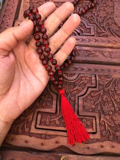 The beads of this mala are 100 % authentic and original. Tibetan / Mahayana style mala. Can be worn as a necklace or a wrap bracelet. Mala is made in traditional way with knots between the beads. Total beads 108+1 There are two kinds of sandalwood Red ( Rakta ) and white (Shweta). Rosaries of red sandalwood are useful for propitiating the goddess whereas white are useful for the gods. Red sandalwood is the symbol of Brahma and blessed by Lakshmi. It enlightens the super consciousness, provides i Holistic Mala With 108 Beads For Festival, Red 8mm Spiritual Beads, Red Mala For Meditation With Round Beads, Red Mala With Round Beads For Meditation, Red Round Beads Mala For Meditation, Red 8mm Beads Spiritual Mala, Red Gemstone Beads Mala As Gift, Red Mala With Gemstone Beads As Gift, Red Mala With Round Beads For Gift