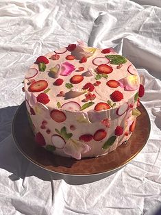 a cake with strawberries and radishes on it sitting on top of a plate