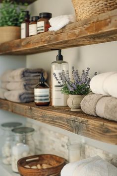 bathroom shelves with towels, soaps and other personal care items on top of them