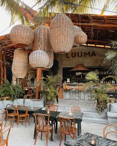 an outdoor restaurant with wicker chairs and tables