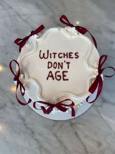 a cake with writing on it that says witches don't age in front of a marble background