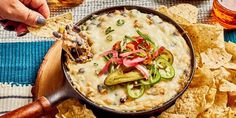 a skillet filled with tortilla chips and vegetables