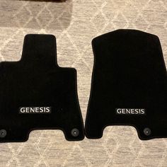 two black carpeted floor mats with the words genius and genius written on them