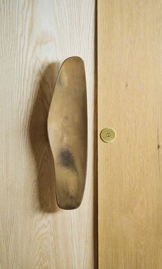 a door handle on the side of a wooden door