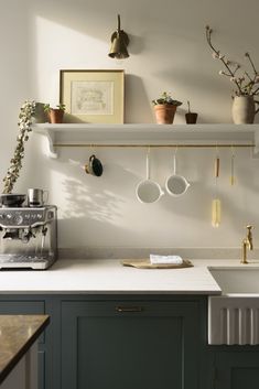 a kitchen with green cabinets and white counter tops