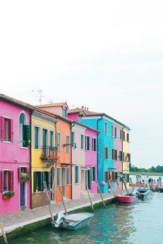 colorful buildings line the water in venice, italy