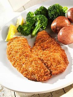 a white plate topped with meat, potatoes and broccoli