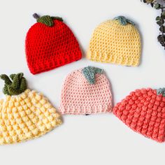 four crocheted hats sitting next to each other