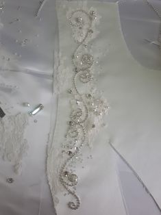 white wedding dress with beaded trim on it