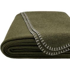 a pile of green blankets folded on top of each other with silver trimmings