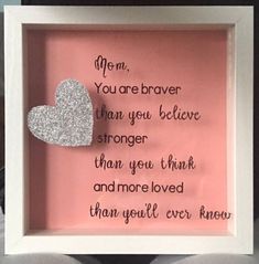 a pink frame with a silver heart in it and some words written on the inside