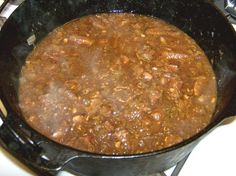 a pot filled with food sitting on top of a stove