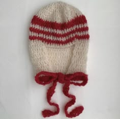 a crocheted hat with red and white stripes