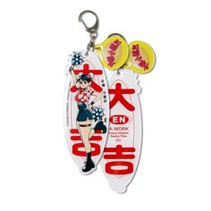 two key chains with an anime character on them, one in the shape of a surfboard