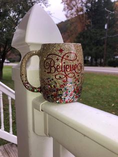 a coffee cup that is sitting on top of a fence post with the word pejego painted on it