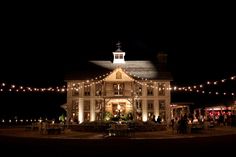 a large white building with lots of lights on it