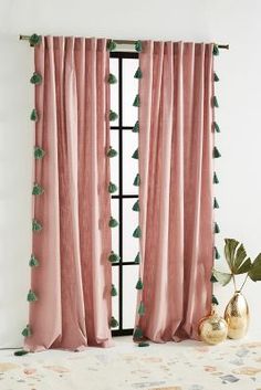 pink curtains with green tassels and pom poms