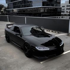 a black sports car parked in a parking lot