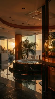 an indoor jacuzzi tub in the middle of a living room with large windows