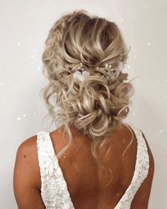 the back of a woman's head wearing a wedding dress