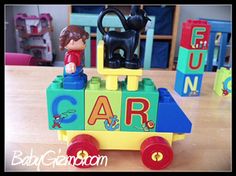 a child's toy train with a cat on the top and letters that spell out car